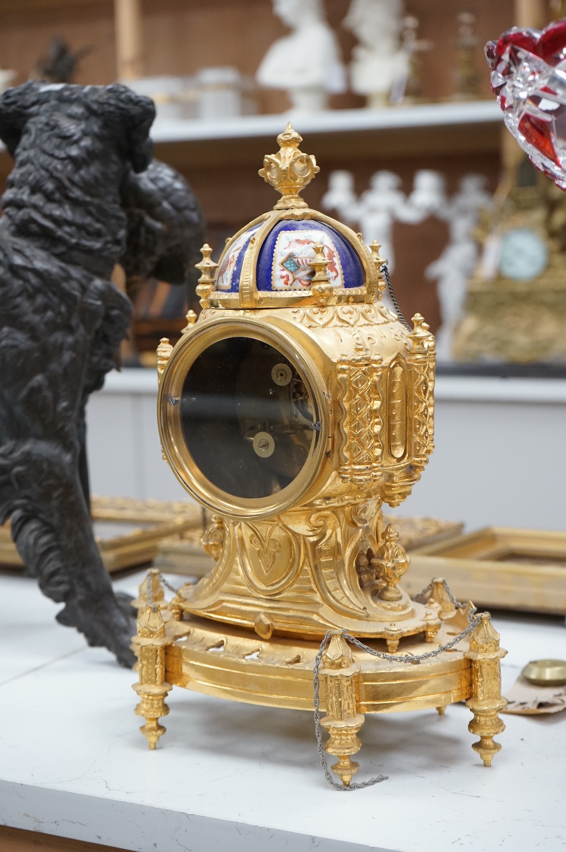 A late 19th century French ormolu mounted clock with enamelled dial and roundels depicting heraldic scenes, the dial inscribed Edward Bright, Paris, with pendulum, no key, 34cm high
